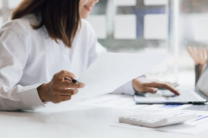 Businesswoman working with laptop and analyzing financial and ac