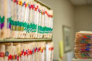 stack-of-medical-charts-in-a-medical-office-space